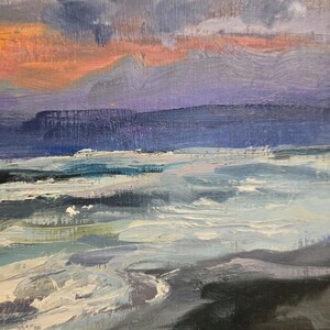 May include: An oil painting depicting a seascape at sunset. The sky transitions from orange to purple and blue, with dark clouds. The ocean has white waves and a dark shoreline.