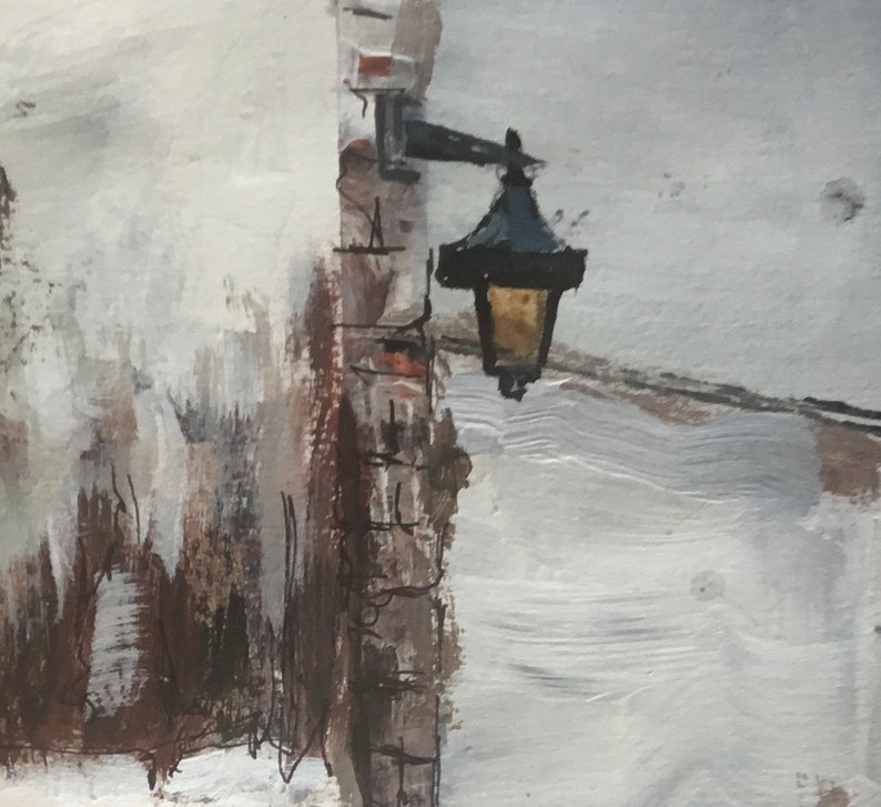 May include: A black street lamp with a white light fixture mounted on a brick wall. The wall is painted in shades of white and brown.