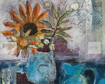 May include: A still life painting of a blue vase with a sunflower and other flowers. The vase is on a table with a blue pitcher in the background.