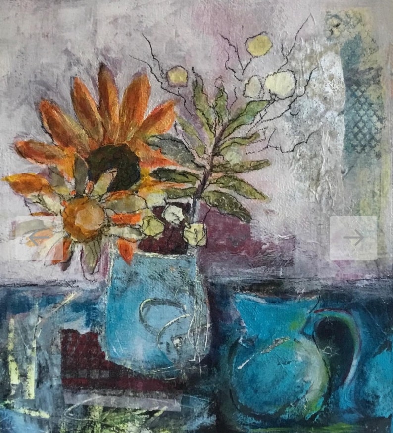 May include: A still life painting of a blue vase with a sunflower and other flowers. The vase is on a table with a blue pitcher in the background.