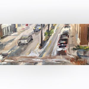 May include: An oil painting depicting a city street scene with cars driving on a sloped road. The artwork features muted colors, with buildings lining the street and a signature in the bottom right corner.