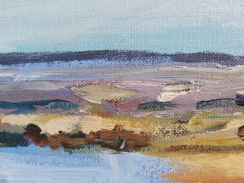 May include: Abstract painting of a landscape with a blue sky, purple mountains, and a brown foreground. The painting is done in a loose, impressionistic style.