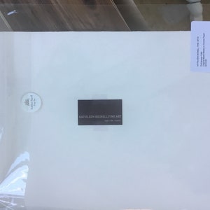 May include: A white card with the text "KATHLEEN BIGNELL FINE ART" printed in black. The card is on a white background.