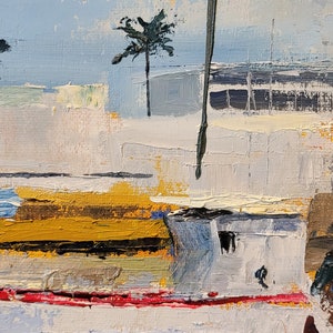 May include: Impasto oil painting of a coastal scene. The artwork features a white structure with yellow and red accents, a palm tree, and a dark, vertical element. The sky is a light blue, and the water is a mix of blues and pinks.