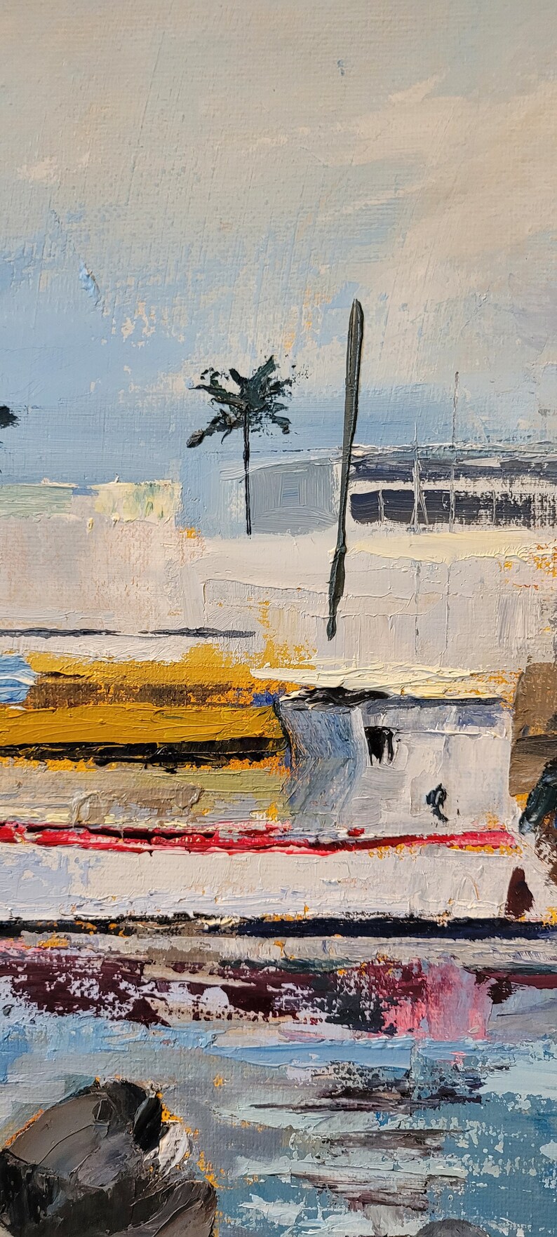 May include: Impasto oil painting of a coastal scene. The artwork features a white structure with yellow and red accents, a palm tree, and a dark, vertical element. The sky is a light blue, and the water is a mix of blues and pinks.
