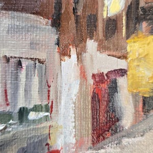 May include: Abstract oil painting with visible brushstrokes. The artwork features a cityscape with buildings in shades of brown, white, and gray, accented by red and yellow. The style is impressionistic.