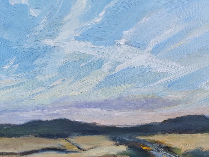 May include: A painting of a landscape with a blue sky and white clouds. The sky is painted with long, horizontal strokes of blue paint. The clouds are white and fluffy, and they are painted with short, vertical strokes of white paint. The landscape is painted in shades of green and brown, and it is painted with short, horizontal strokes of paint.