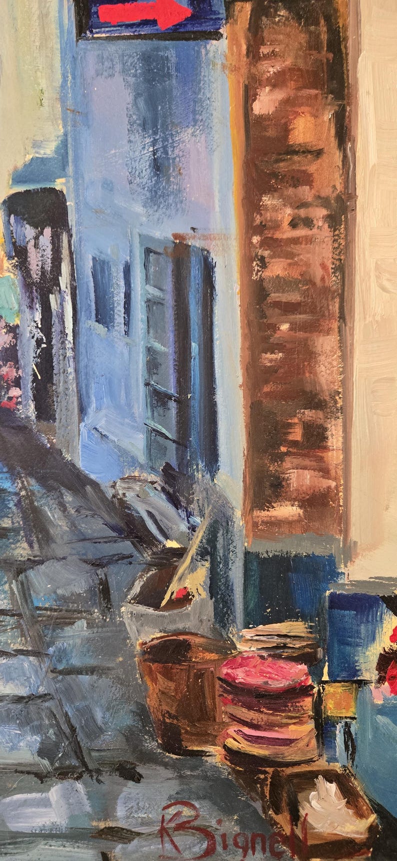 May include: An impressionistic oil painting of a European street scene. The artwork features a blue building with a red arrow sign, a brick wall, and various objects, including wooden barrels and a sign with the artist's signature.