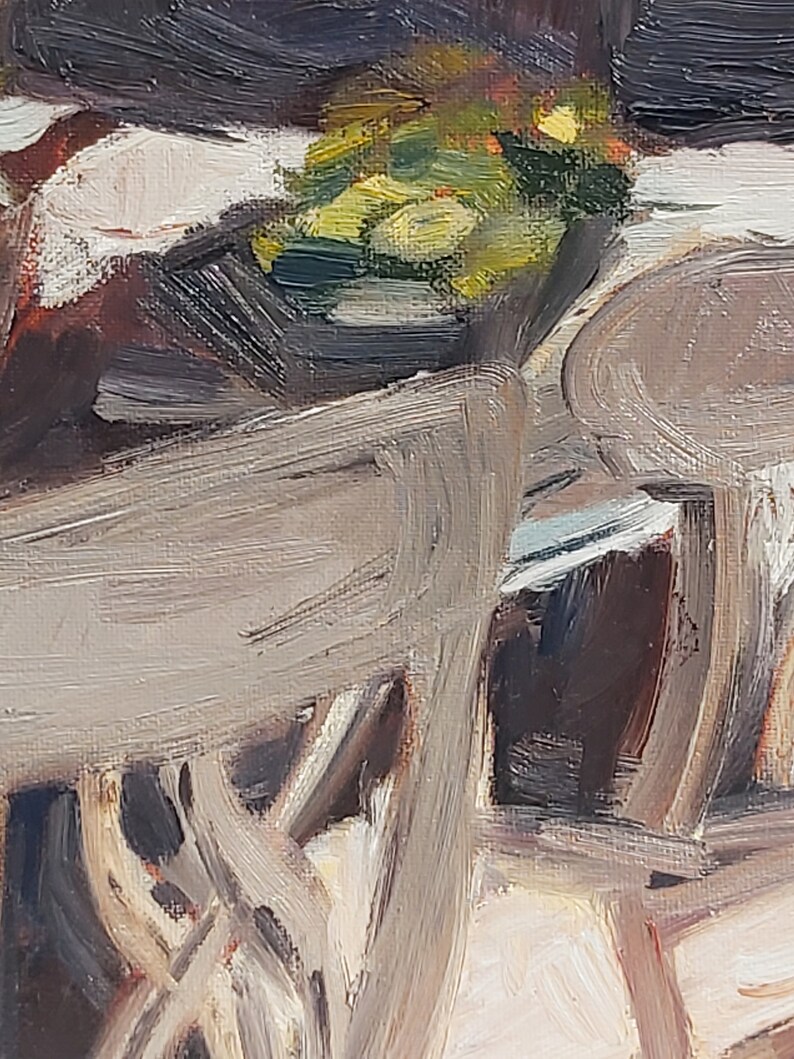 May include: A close-up of a wooden chair with a light brown finish. The chair is partially obscured by a bowl of green and yellow fruit.