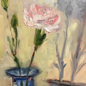 May include: Oil painting of a pink carnation flower in a blue vase. The flower has multiple layers of petals and is surrounded by green stems and buds. The background is a soft yellow and the painting has a textured appearance.