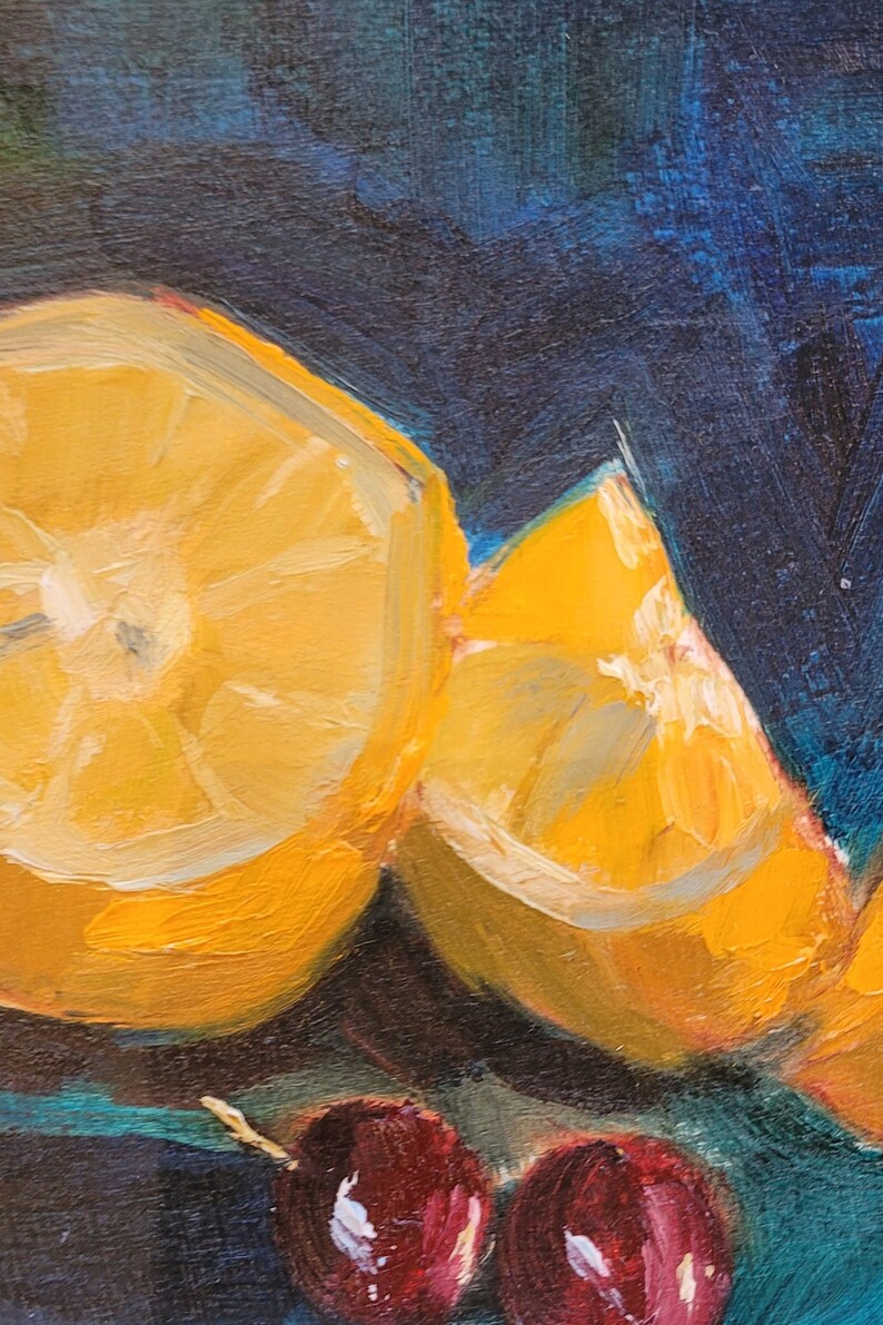 May include: A still life painting of two lemon halves and three red grapes on a dark blue background. The lemons are sliced open and show the yellow flesh inside. The grapes are clustered together and have a deep red color.