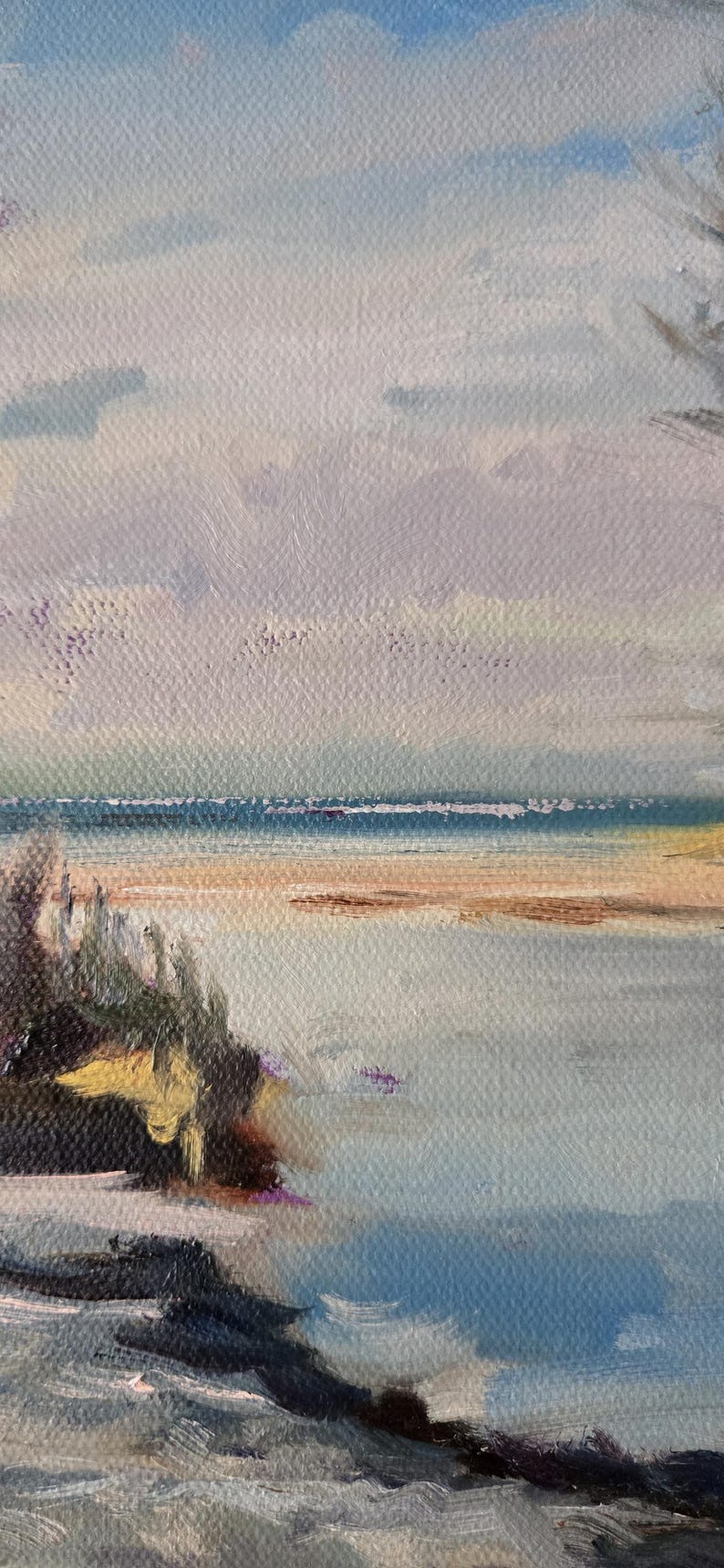 May include: A painting of a seascape with a blue sky and a sandy beach. The water is a light blue and the sand is a light brown. There are some green bushes in the foreground.