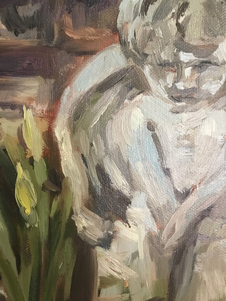 May include: A close-up of a painting depicting a person with a white shirt and a bouquet of yellow flowers in the foreground.