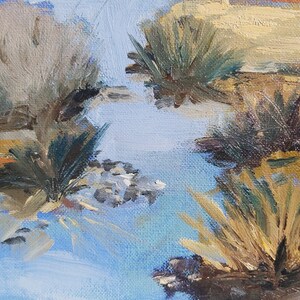 May include: A painting of a blue sky with brushstrokes of white and yellow. The sky is reflected in a body of water, and there are green and brown brushstrokes of grass and reeds around the water.