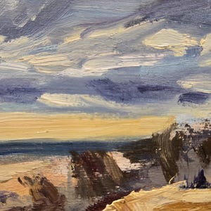 May include: An oil painting on canvas depicting a coastal landscape with thick, visible brushstrokes. The scene features a sandy foreground in shades of tan and brown, a dark blue ocean horizon, and a dramatic sky filled with swirling blue and white clouds.