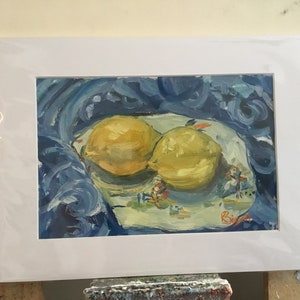 May include: A painting of two yellow lemons on a white plate with blue and white floral designs. The plate is on a blue cloth with swirling brushstrokes. The artist's signature is in the bottom right corner.