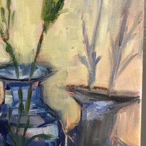 May include: An oil painting depicts a still life of flowers in blue vases. The flowers are light pink and white, with green stems and leaves. The vases are a deep blue, and the background is a soft yellow.