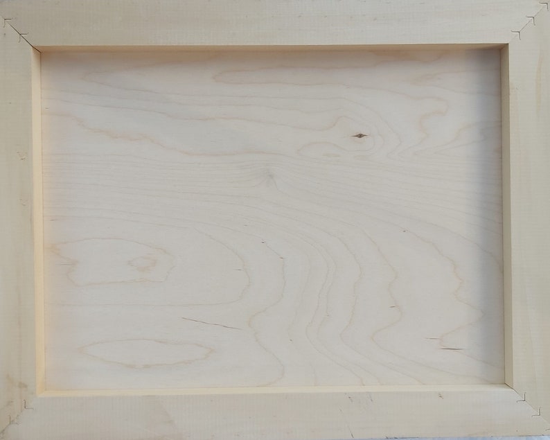 May include: A plain, light wood frame with a smooth, natural finish. The frame is made of solid wood and has a simple, rectangular shape.