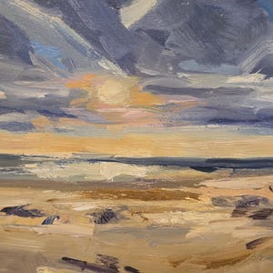 May include: An oil painting on canvas depicting a coastal landscape at sunset. The scene features a sandy beach in the foreground with visible brushstrokes in shades of beige and brown, leading to a dark blue ocean and a cloudy, textured sky.