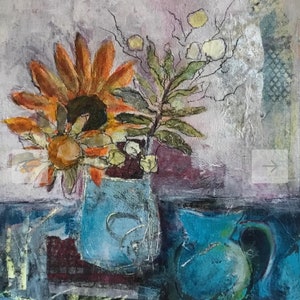 May include: A still life painting of a blue vase with a sunflower and other flowers. The vase is on a table with a blue pitcher in the background.