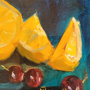 May include: A still life painting of three orange lemon slices and four red cherries on a teal background. The artist's signature, "Bignell", is in the bottom right corner.