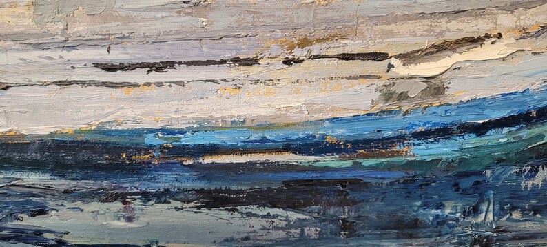 May include: Abstract oil painting with a textured surface. The artwork features horizontal bands of color, including shades of blue, white, gray, and gold. The brushstrokes create a sense of depth and movement, evoking a landscape or seascape.