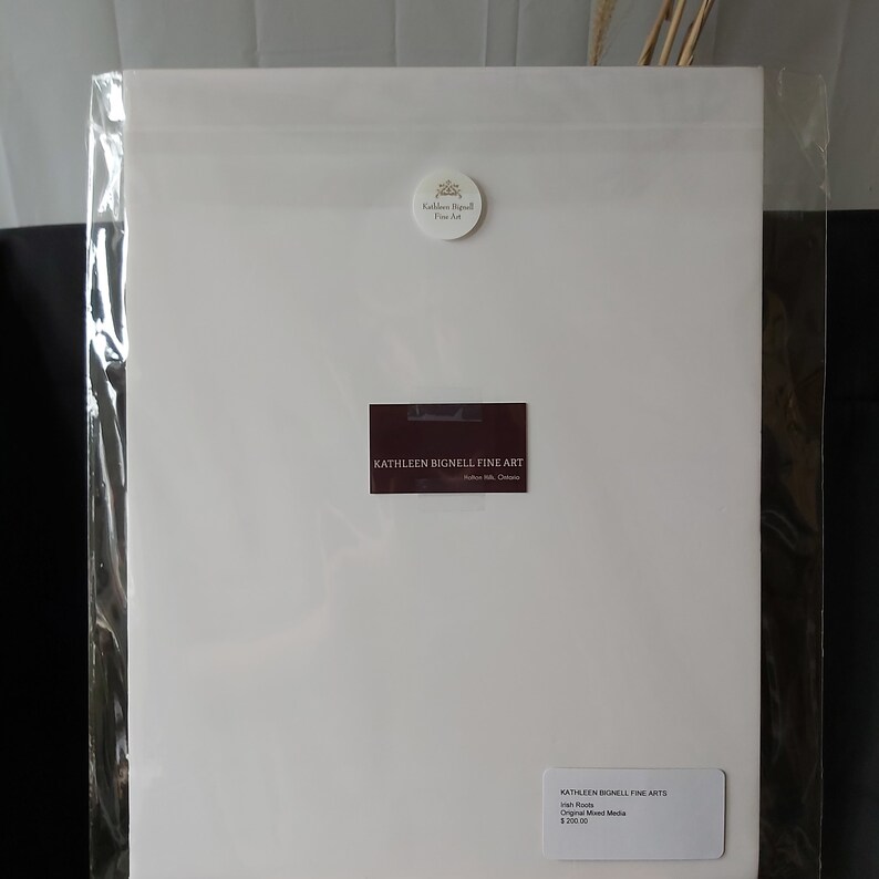May include: A white sheet of paper with a business card for Kathleen Bignell Fine Art. The card is burgundy with white text. The text on the card reads "Kathleen Bignell Fine Art" and "kathleenbignell.com". There is a small white circle sticker with a logo and the text "Kathleen Bignell Fine Art" on the top of the sheet of paper.