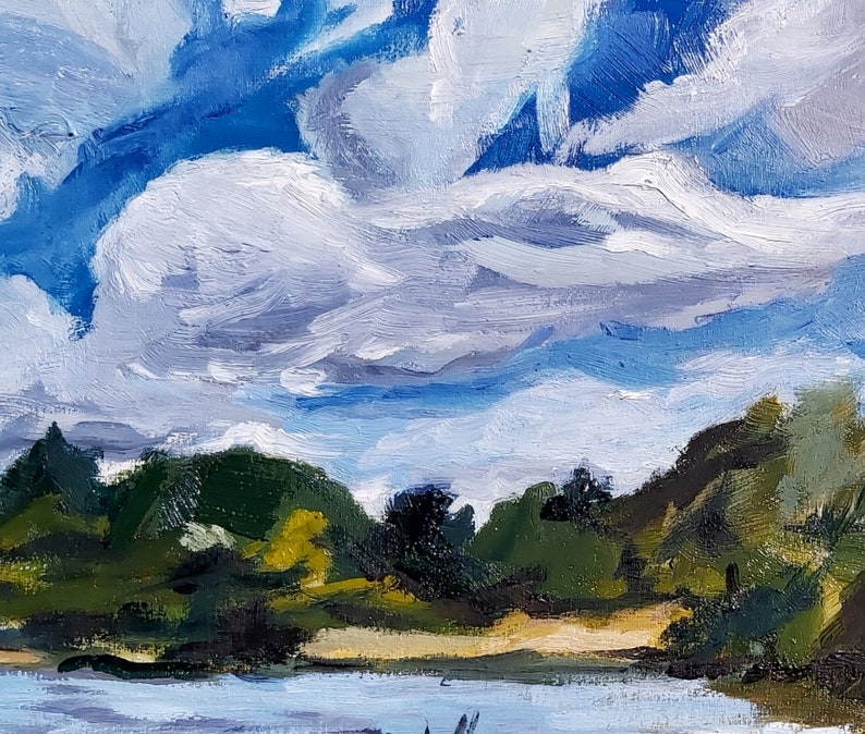 May include: Oil painting of a landscape featuring a bright blue sky filled with fluffy white clouds. The foreground shows a body of water, with green trees and foliage along the horizon. The artwork uses thick brushstrokes.