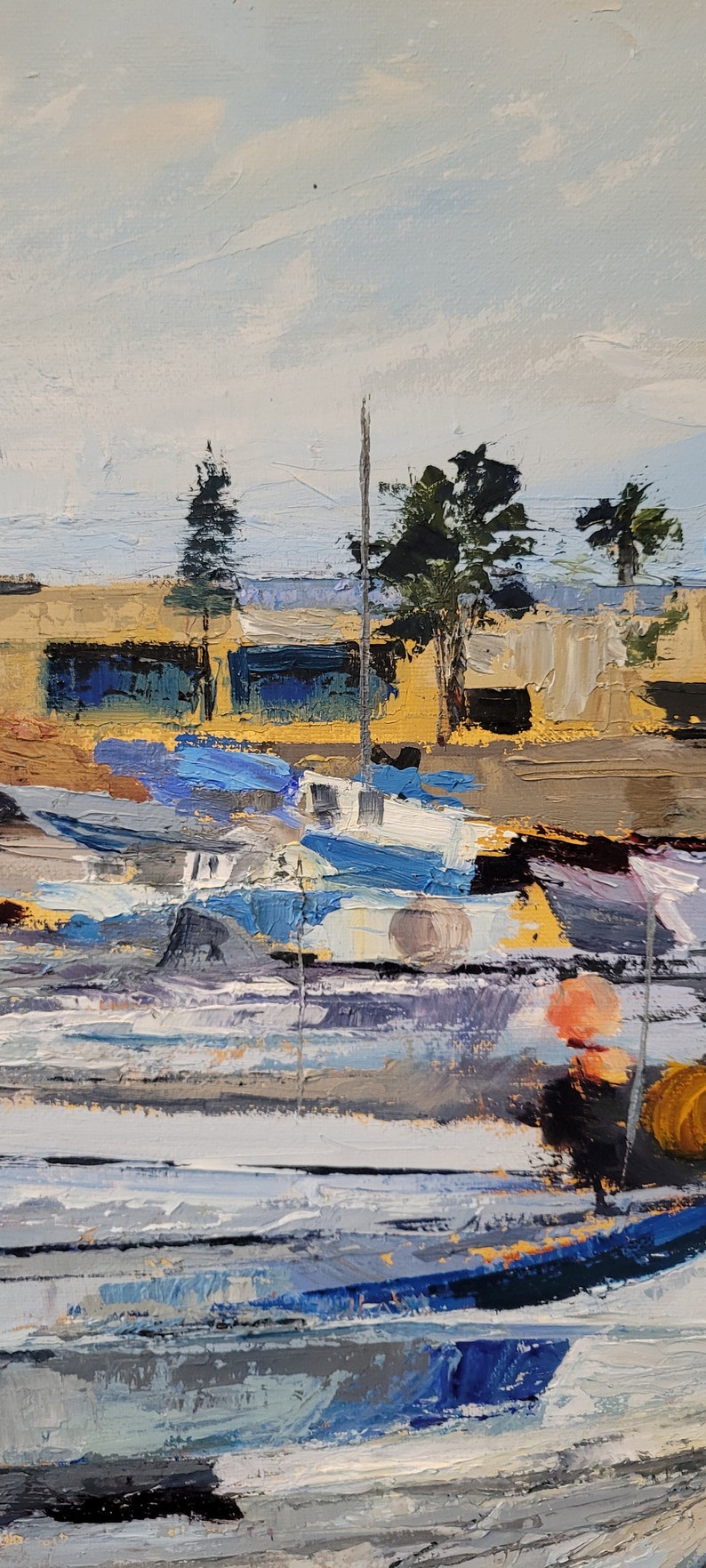 May include: Impressionistic oil painting of a harbor scene. The artwork depicts boats in shades of blue and white, with a backdrop of buildings and trees under a light blue sky. The brushstrokes are thick and textured, creating a sense of depth and movement.