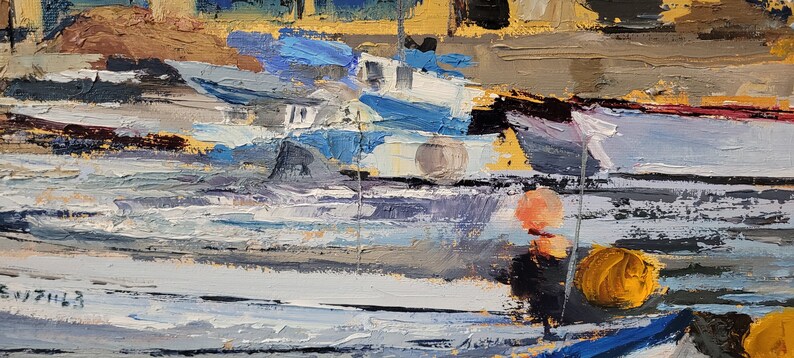 May include: An impressionistic oil painting of a harbor scene. The artwork features boats in shades of blue and white, with yellow and orange buoys. The water is depicted with textured brushstrokes, and the background shows buildings with yellow and brown tones.