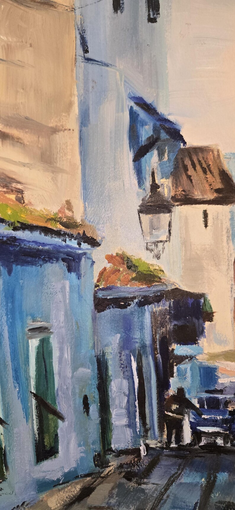 May include: An abstract painting of a European street scene. Buildings are painted in shades of blue, white, and tan, with a street and a person in the foreground. A street lamp hangs from a building.