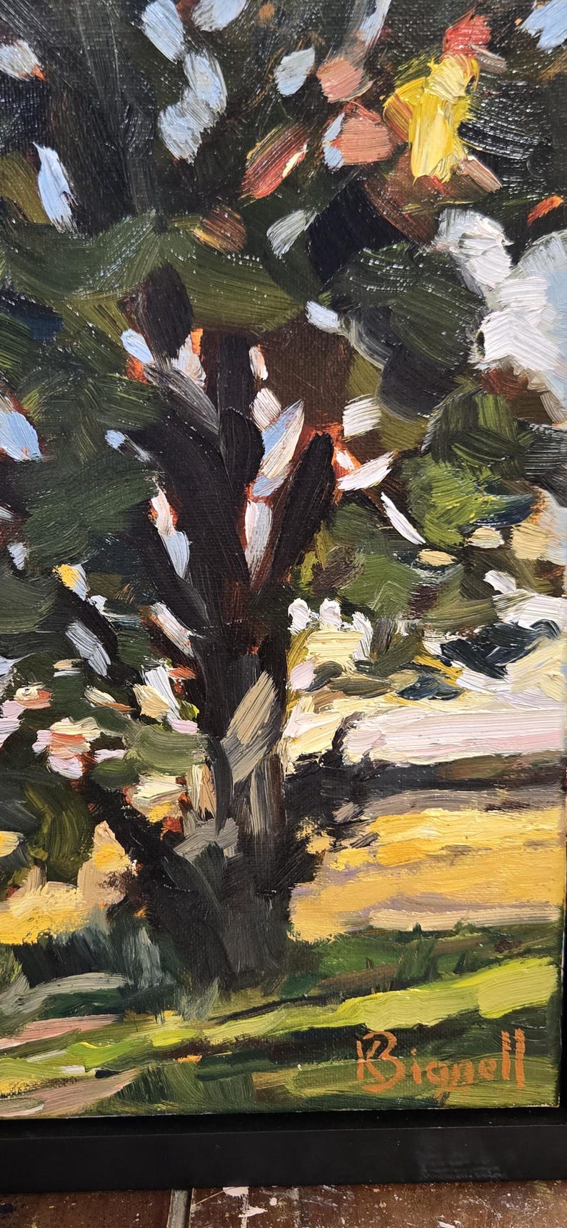 May include: An oil painting depicting a tree with a dark brown trunk and green leaves. The background features a yellow and green field. The artist's signature, Bignell, is visible in the bottom right corner.