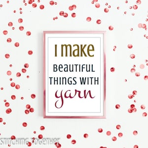May include: A framed print with the text "I make beautiful things with yarn" in a pink frame against a white background with pink confetti.