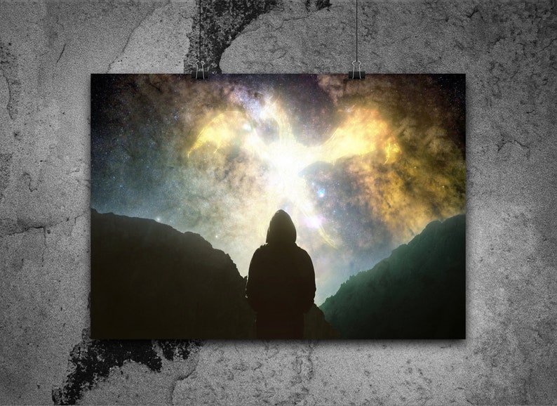 May include: A silhouette of a person standing in front of a mountain range, looking up at a bright, colorful nebula in the night sky.