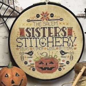 May include: A cross-stitch pattern featuring a vintage-style illustration of a pumpkin with the text "The Salem Sisters Stitchery" and "Silks Linen Wool Buttons".