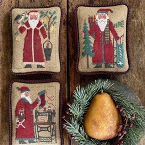 May include: Four embroidered pillow covers featuring a red-clad Santa Claus in various holiday scenes. The scenes include Santa with a bird, Santa with a tree and a bag of gifts, Santa with a sewing machine and scissors, and Santa with a bucket and a pear tree.