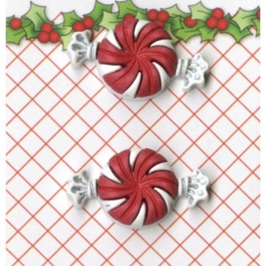 May include: Three red and white candy cane buttons with silver foil wrappers. The buttons are on a white and red checkered background with a green holly border and the text "Holiday Fun!" at the top. The text "Buttons Galore & More" is at the bottom of the image.
