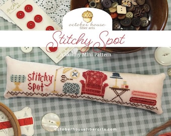 May include: A cross-stitch pattern with the words "Stitchy Spot" and various sewing-themed illustrations. The design includes a red armchair, a lamp, and a table. The background features buttons and fabric.