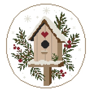 May include: A cross-stitch pattern featuring a light brown birdhouse with a dark red heart, a black entrance hole, and white snow on the roof and base. The birdhouse is surrounded by green pine branches with red berries and white snowflakes.