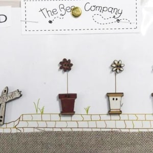 May include: A set of three ceramic mugs with a speckled, matte finish. The mugs are in shades of cream, light gray, and dark gray. Each mug has a simple, minimalist design and a rounded handle. The mugs are likely for coffee or tea.