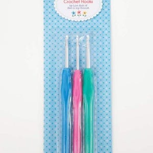 May include: A package of three crochet hooks, one blue, one pink, and one green. The package is labeled "100% Cute Crochet Hooks by Lori Holt of Bee in My Bonnet."