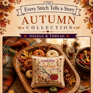 May include: A square cross-stitch sampler featuring the text needle & thread, a pair of scissors, and a tomato pincushion. The design is surrounded by autumn-themed motifs including leaves, acorns, and berries, presented in a wooden bowl.