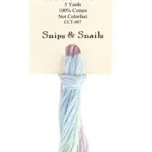 May include: A skein of Classic Colorworks embroidery floss in the color "Snips & Snails". The floss is a blend of light blue, green, and purple.