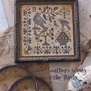 May include: A framed cross-stitch sampler with a bird and floral design. The sampler features two birds perched on branches, a small bird, and a floral basket. The frame is dark brown, and the background is a neutral color. The text "It's Spring Fever" is visible.
