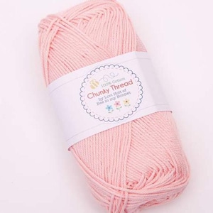 May include: A skein of light pink chunky cotton yarn. The yarn is wrapped with a white label that reads "Chunky Thread" and "100% Cotton" with a bee and flower design. The yarn is by Lori Holt of Bee in my Bonnet.