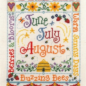 May include: A cross-stitch pattern featuring the months of June, July, and August with a beehive and the text "Summer Days & Berries & Blooms, Buzzing Bees".