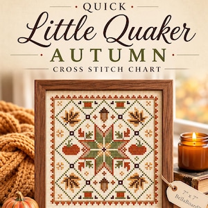 May include: A framed cross stitch chart titled Quick Little Quaker Autumn featuring a central star surrounded by autumn leaves, pumpkins, and acorns in shades of orange, green, and brown on cream fabric, with a 17.8 cm by 17.8 cm label attached.