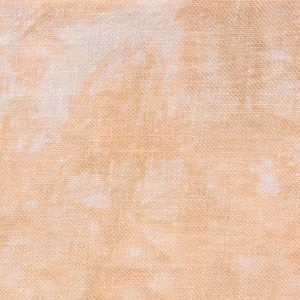 May include: Close-up of a textured fabric with a peach and white tie-dye pattern. The fabric has a woven appearance, with visible threads creating a grid-like texture. The color palette is soft and muted, with a blend of peach and white hues.