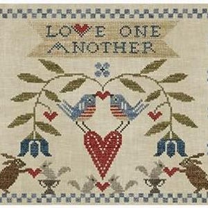 May include: Cross-stitch sampler with the text "LOVE ONE ANOTHER" above a design featuring two blue birds kissing, a large red heart, and two brown rabbits holding hearts. The sampler has a beige background with blue and green accents.