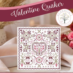 May include: A square cross-stitch pattern with a Valentine's Day theme. The design features a heart, flowers, and geometric shapes in shades of pink, green, and white. The words "Valentine Quaker" are written across the top.